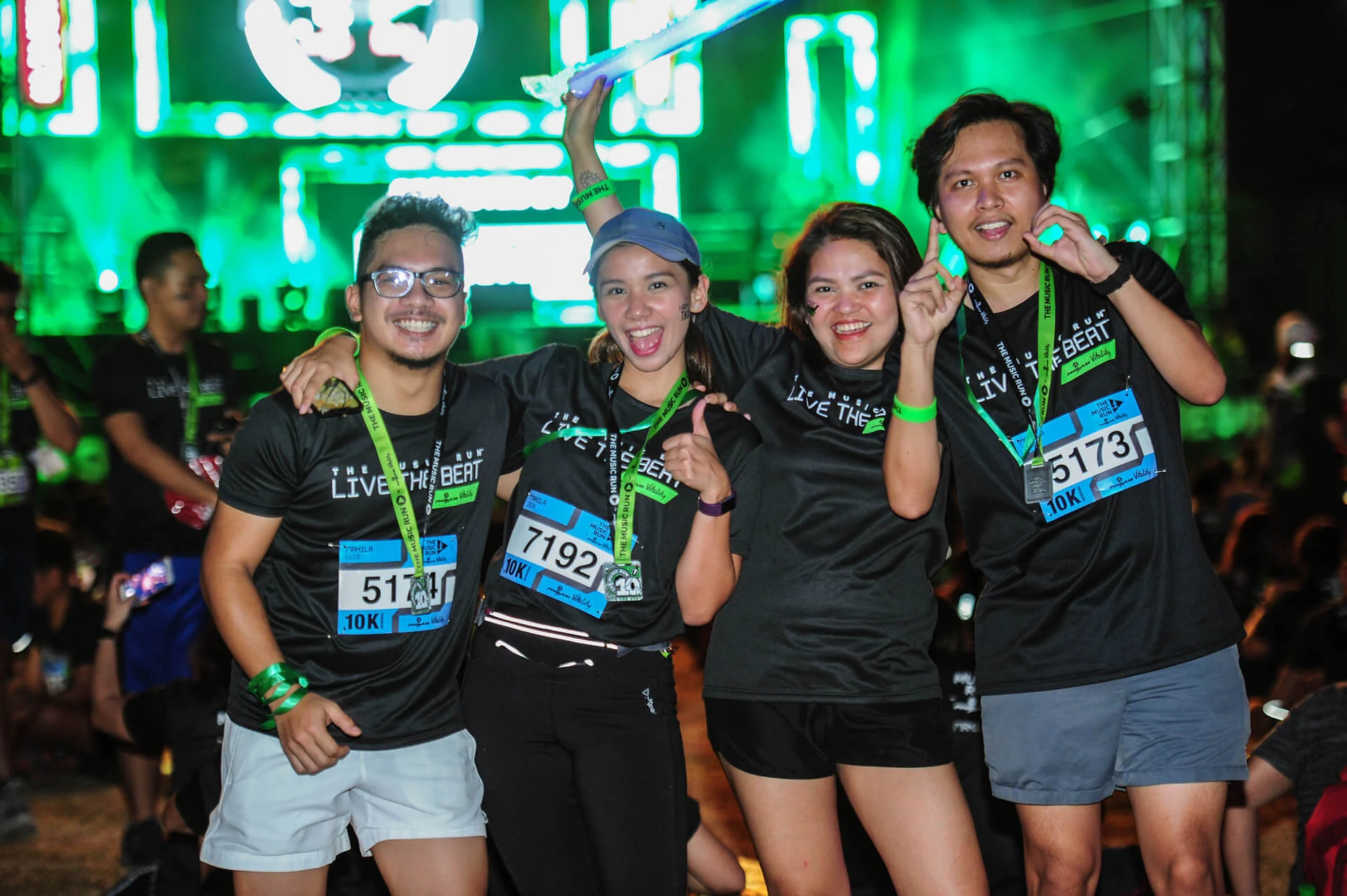 Four Music Run Manila participants celebrating together after the event